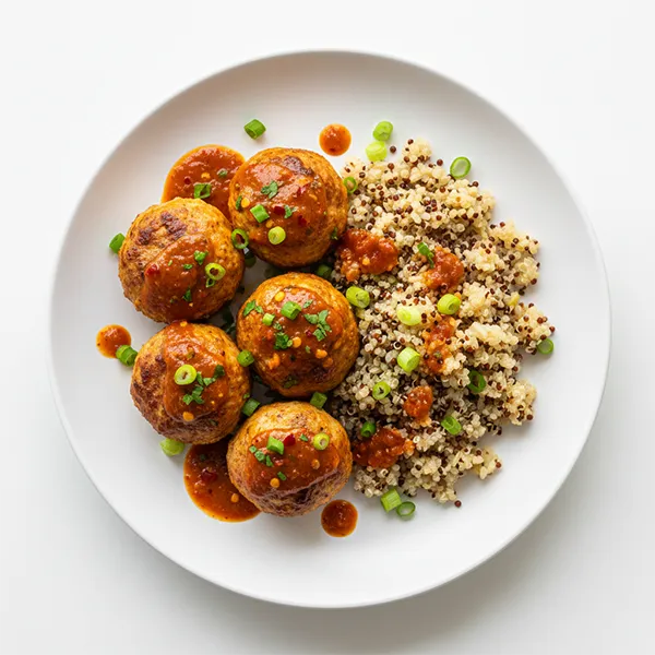 Zingy chicken meatballs with quinoa rice and creole drizzle